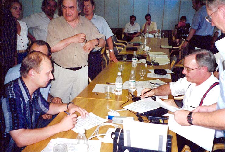Sergei Badin (left) and Jim Jefferis (right) signing initial contracts for the Sarov Open Computing Center. Vladimir Rogachev is standing next to Badin.